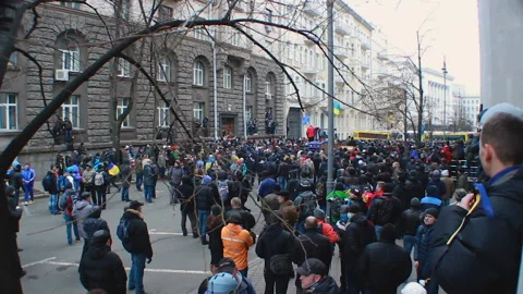 Large crowd of demonstrators gathered in small blocked street, public objection Stock Footage 85873755