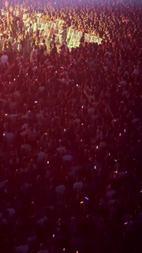 Large crowd enjoying concert with stage lights Stock Footage 340264299