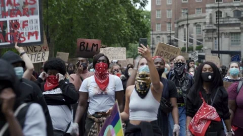 A large crowd of female Black Lives Matter protesters marching down Park Lane Stock Footage