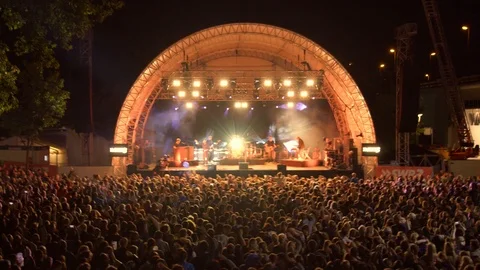 Large Crowd in front of a Big Stage at Open Air Concert Stock Footage