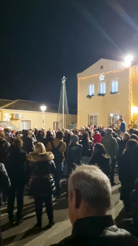 Large crowd gathered at night for festive Christmas tree lighting ceremony in Stock Footage 341727142
