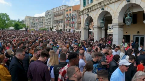 Large crowd gathering in historic Corfu Town Spianada square near Liston during Stock Footage 326566538