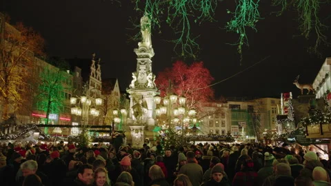A large crowd gathers around the illuminated Jan von Werth fountain Stock Footage 340281879
