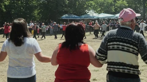 Large Crowd of happy people dance a Bulgarian traditional horo at festival Stock Footage 193370001
