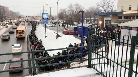 Large crowd of passengers waiting for buses after evacuation from train. Stock Footage 98973055