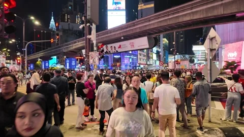 A large crowd of people are walking down a street Stock-Footage 318093696