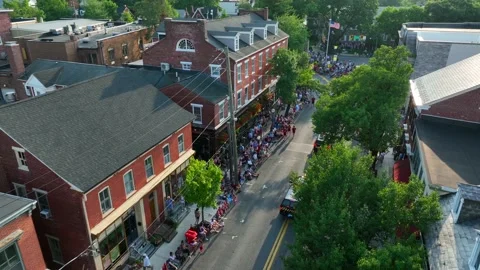 Large crowd of people enjoy parade in historic American town. USA flag Stock Footage 200499831