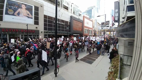 Large crowd of people walking down Younge St in Toronto, Canada at Trump protest Stock Footage 91919766