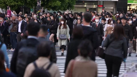 Large crowd of people walking through the Shibuya Crossing Stock Footage 262826768