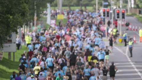 Large Crowd of Runners in Marathon Race Jogging in Slow Motion Stock Footage 346584278
