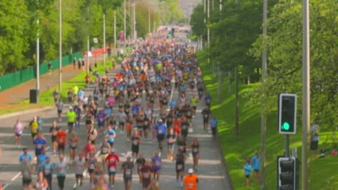 Large Crowd of Runners in Race with In Camera Slow Shutter Speed Stop Motion Stock Footage 347760423