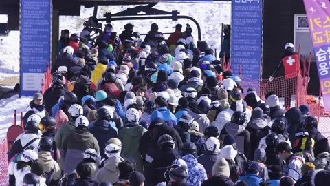 A large crowd of skiers in the queue in front of the ski lift. Video stock 232869312