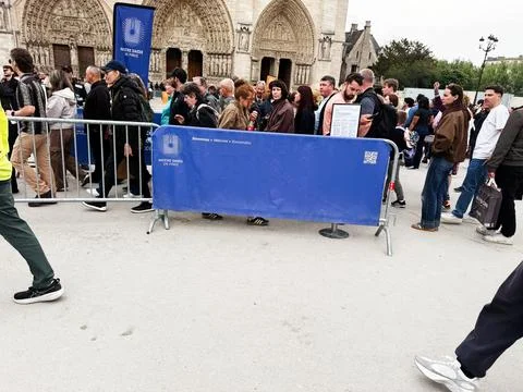 Large crowd of tourists queuing outside Notre Dame cathedral in Paris, Fran.. Stock Photos