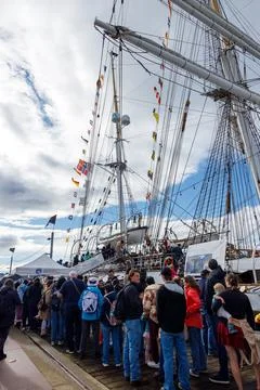 Large crowd of visitors lining dock to tour Norwegian tall ship Statsraad L.. Stock Photos