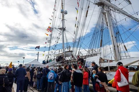 Large crowd of visitors lining dock to tour Norwegian tall ship Statsraad L.. Stock Photos