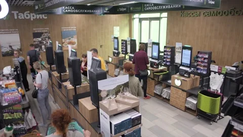 Large crowds at interactive self-pay checkouts for merchandise. Timelapse Video stock 247465293