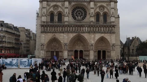 Large crowds of tourists in front of Notre Dame cathedral in Paris, wide view. Stock Footage 332944721