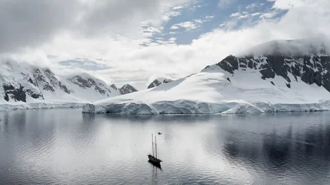 Large cruise ship and sailing boat in the bay near the Antarctic peninsula, a Stock Footage 263242098