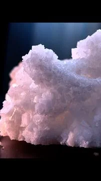 Large crystal formations sit on smooth surface jagged texture capturing light Stock Photos