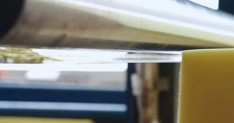 Large cube of synthetic foam on conveyor, knife cuts foam into thin layers Stock Footage 128636865