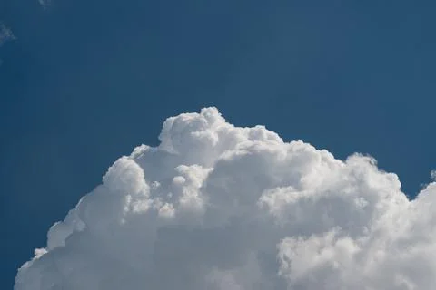 Large cumulus cloud against deep blue sky Photos
