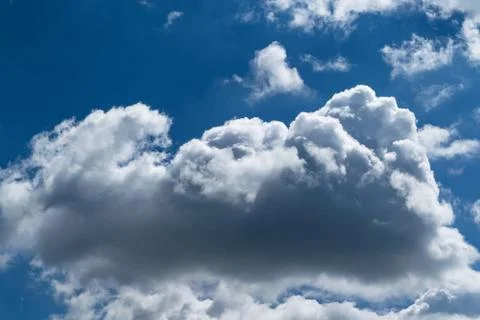 A large Cumulus cloud in the blue clear sky. Stock Photos