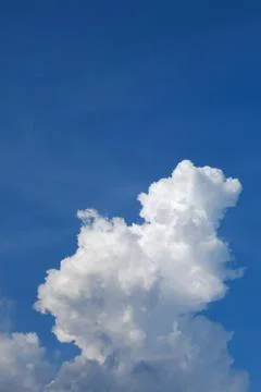 Large cumulus cloud on clear blue sky background Stock Photos
