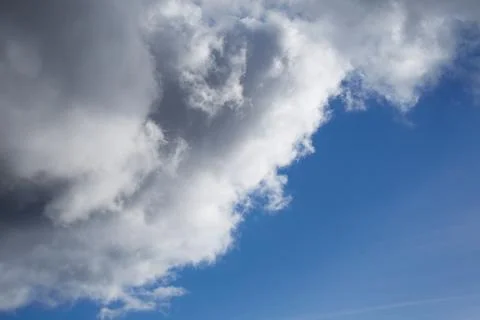 A large cumulus cloud covers the blue sky, a large cloud covers the blue sky Stock Photos