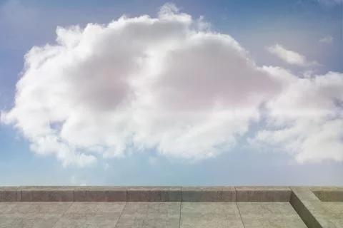 Large cumulus cloud floating above stone-tiled terrace under clear blue sky in Ilustração Stock