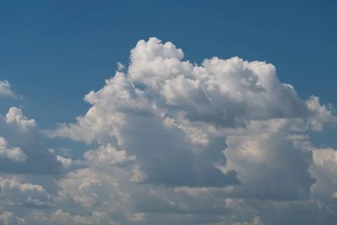 Large cumulus cloud formation against clear blue sky Stock Photos