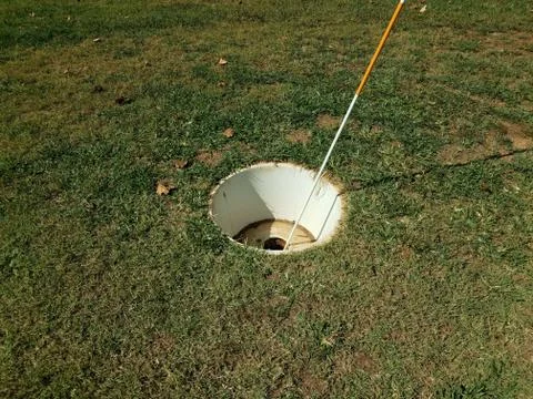 Large cup or hole with flag stick for foot golf Stock Photos