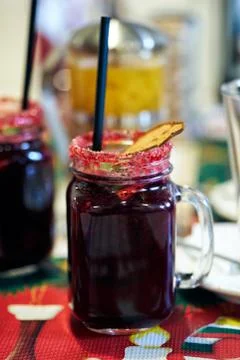 A large cup of red fruit drink with a straw. Stock Photos