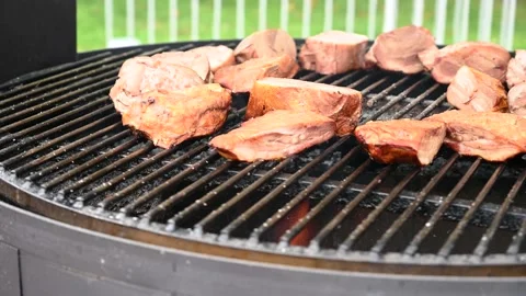Large cuts of beef are cooked on rotating outdoor grill. Street food concept Stock Footage 162096476