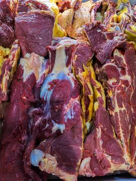 Large cuts of raw beef displayed in butcher shop Photos