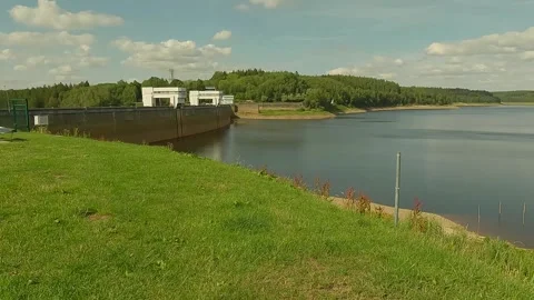 A large dam holding back a beautiful river in a forest. Stock Footage 247134322