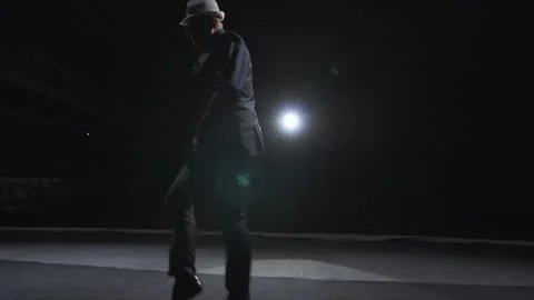 Large dark scene in theater with dancing adult man in suit and hat. Soffit light Vídeo Stock 263055112