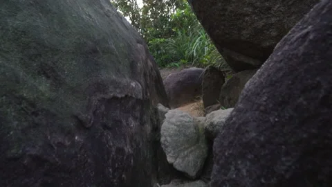 Large dark stones lie on ground in hill in Hong Kong Stock Footage 157246779