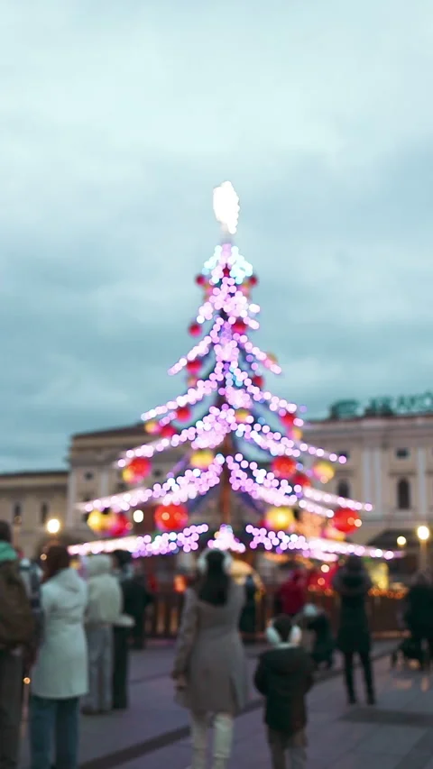 Large decorated Christmas tree on city square market at winter day Stock Footage 342242096