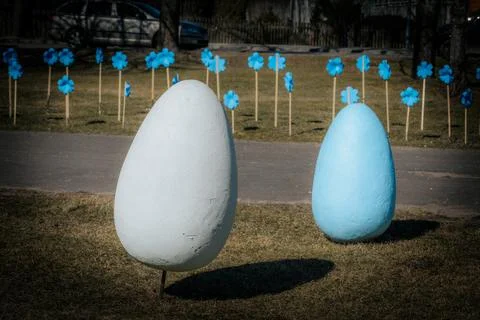 Large decorative Easter eggs in pastel blue, white and gold. Фото