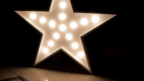 Large decorative retro star with lots of burning lights on grunge concrete Stock Footage 90893203
