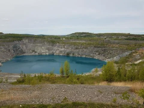 Large deep blue lake where asbestos was mined in Canada Stock Photos