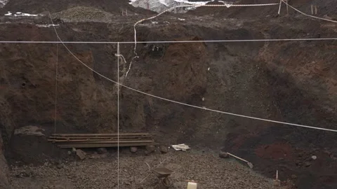 Large deep mud pit at a construction site Видео 165251839