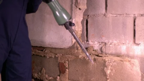 Large Demolition Hammer on Cinder Block Wall Video stock 123322590