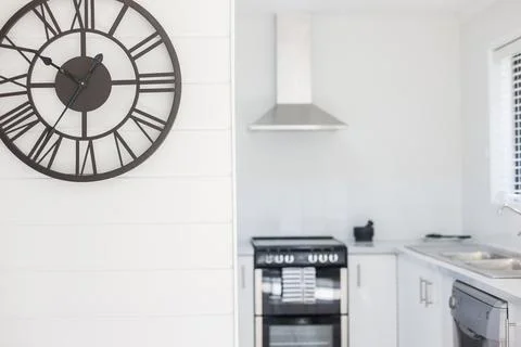 Large Designer Wall Clock with a Contemporary Look and Roman Numeral Markers Stock Photos
