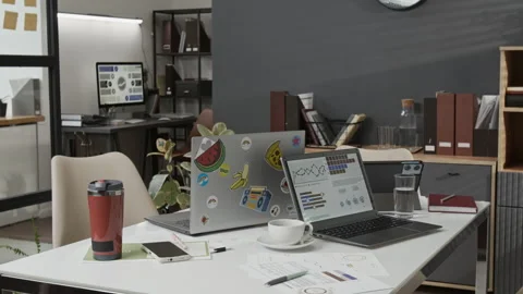 Large Desk with Two Laptops, Notebook, Documents, Coffee Cup, Phone, Travel Mug Stock Footage 330517725