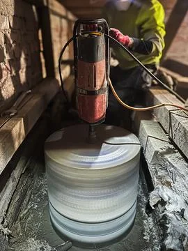 Large diameter core drilling through reinforced concrete slab. Stock Photos