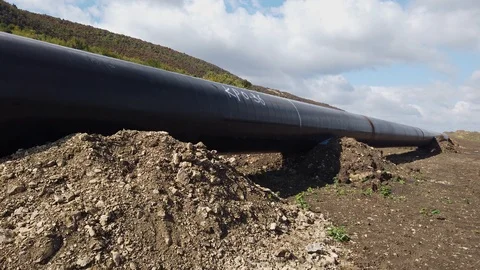 Large diameter welded metal pipes and blue sky Stock Footage 125340422