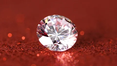 Large diamond rotating on red background Stock Footage 102098693