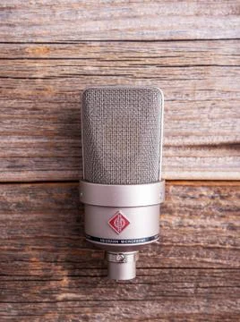 Large diaphragm condenser studio microphone Neumann tlm 103 on a wooden Stock Photos
