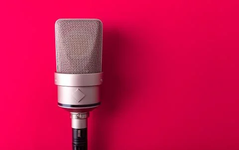 Large diaphragm condenser studio microphone. On red background. Stock Photos